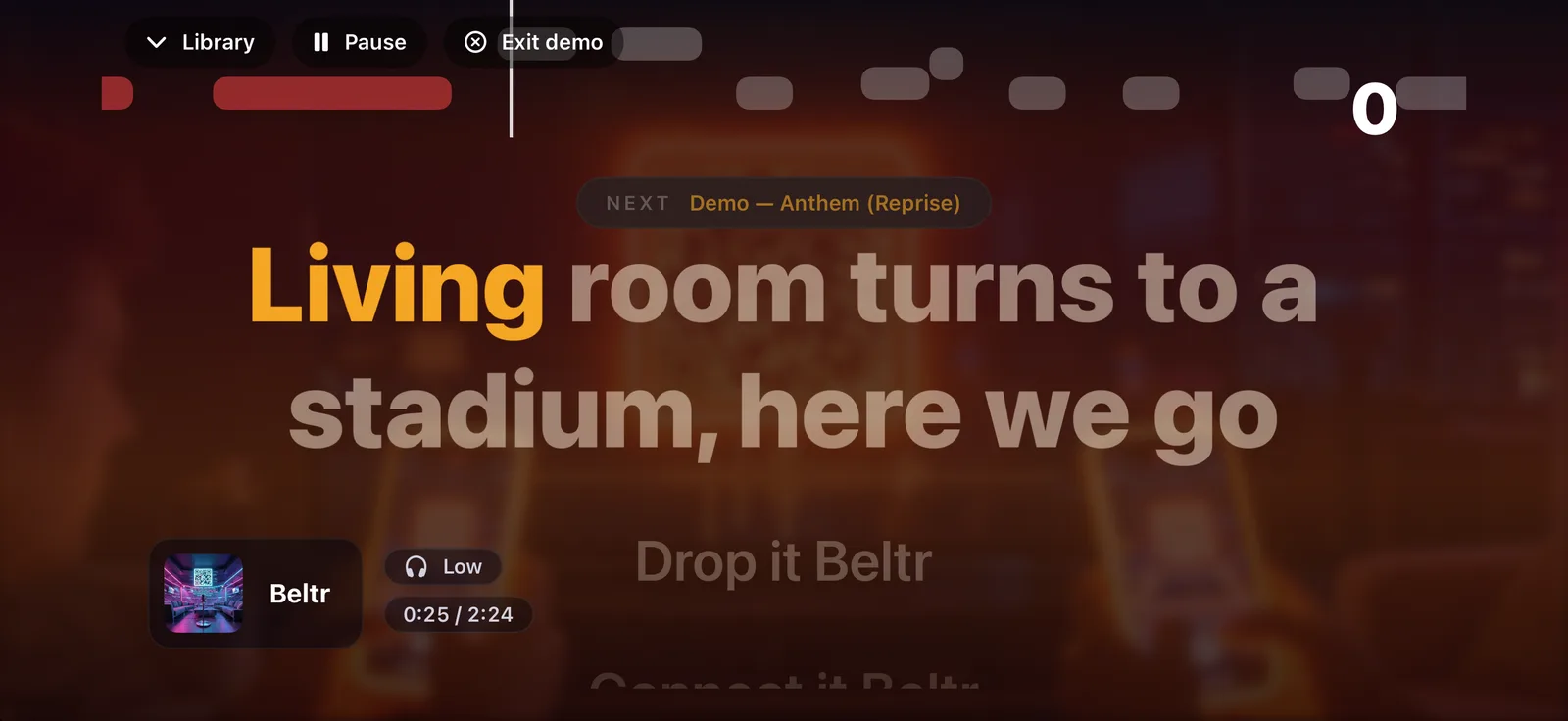 An iPhone held sideways showing the stage itself: the lyric line “Living room turns to a stadium, here we go” lighting up word by word under the pitch bar.